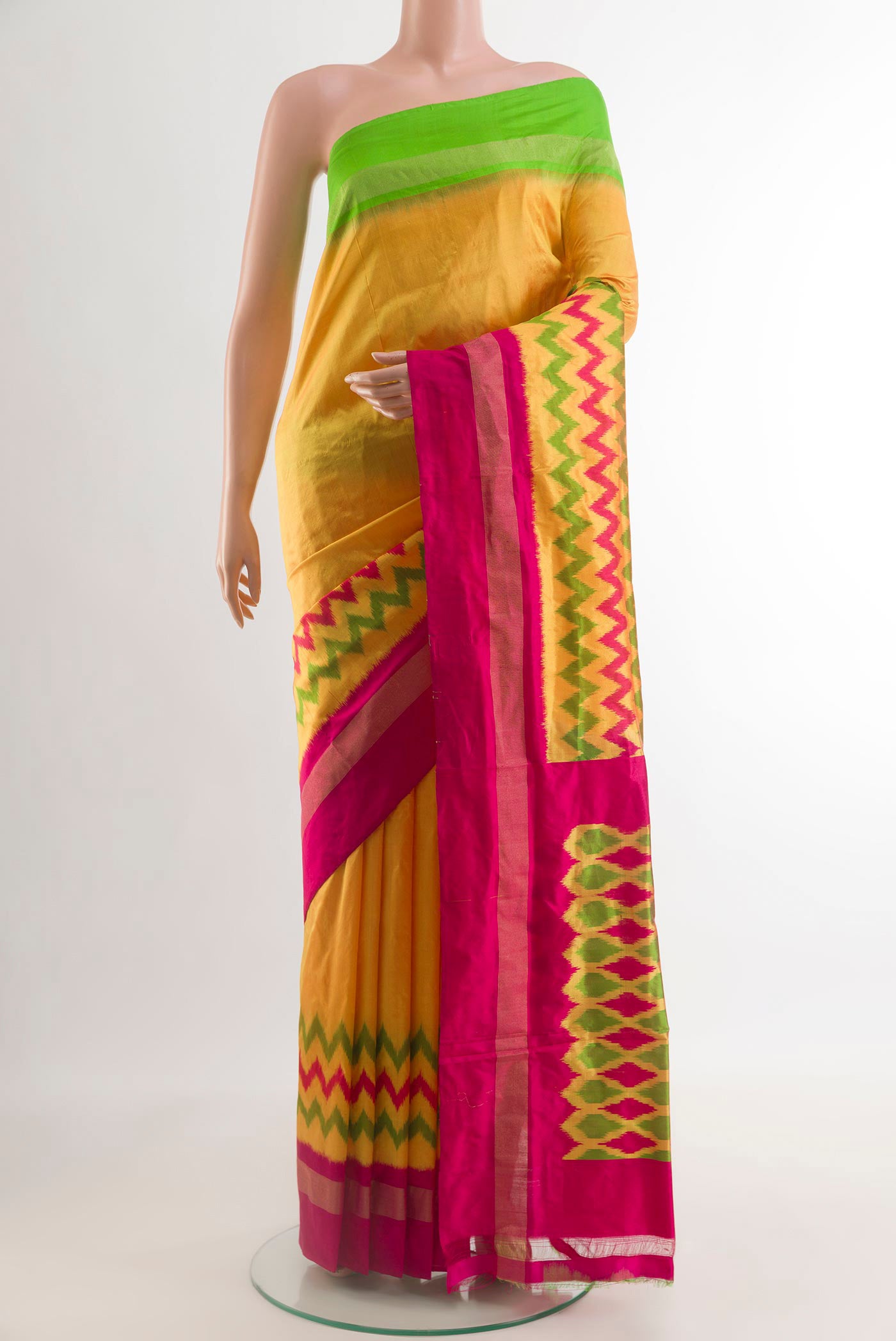 Yellow Pochampally Silk Saree with Pure Ikat on the body and Ganga Jamuna Border.  displayed on a mannequin