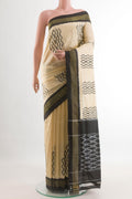 Cream Pochampally Silk Saree with Pure Ikat on the body and Ikat Border.  displayed on a mannequin