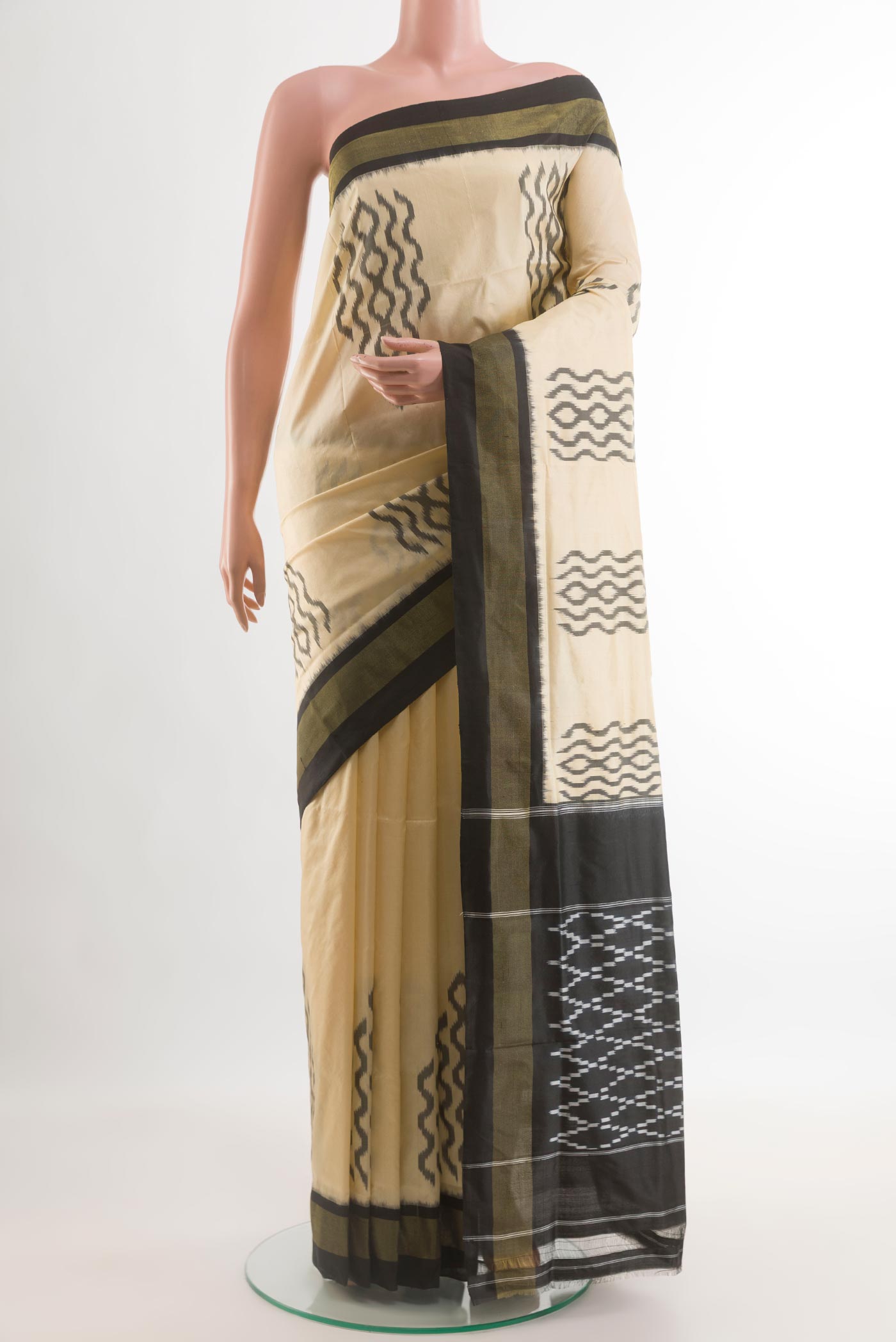 Cream Pochampally Silk Saree with Pure Ikat on the body and Ikat Border.  displayed on a mannequin