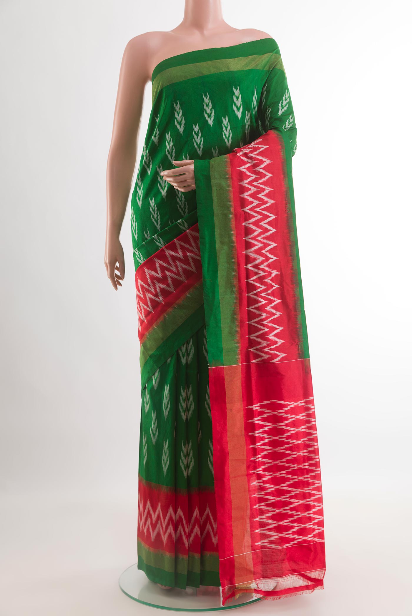 Green Pochampally Silk Saree with Pure Ikat on the body and Ikat Border.  displayed on a mannequin