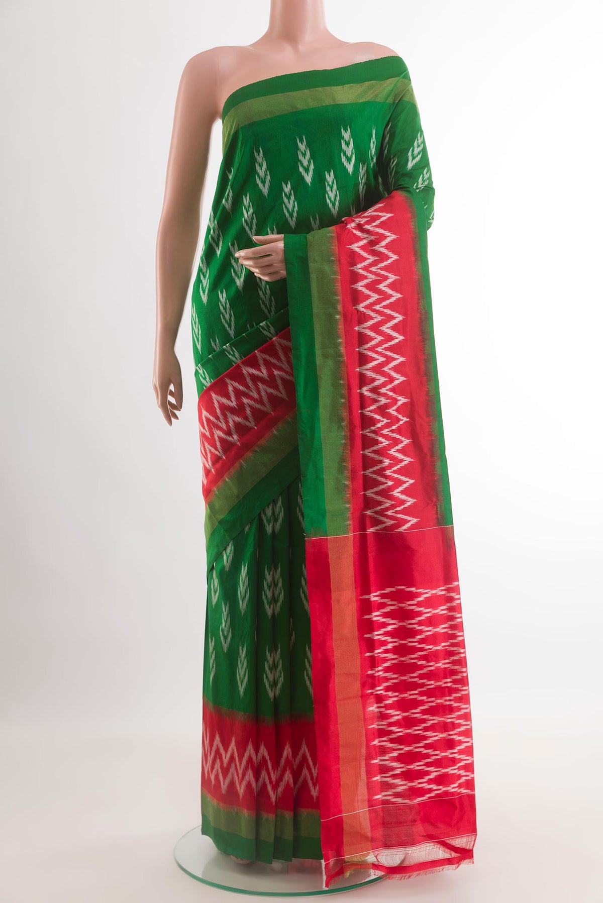Green Pochampally Silk Saree with Pure Ikat on the body and Ikat Border.  displayed on a mannequin