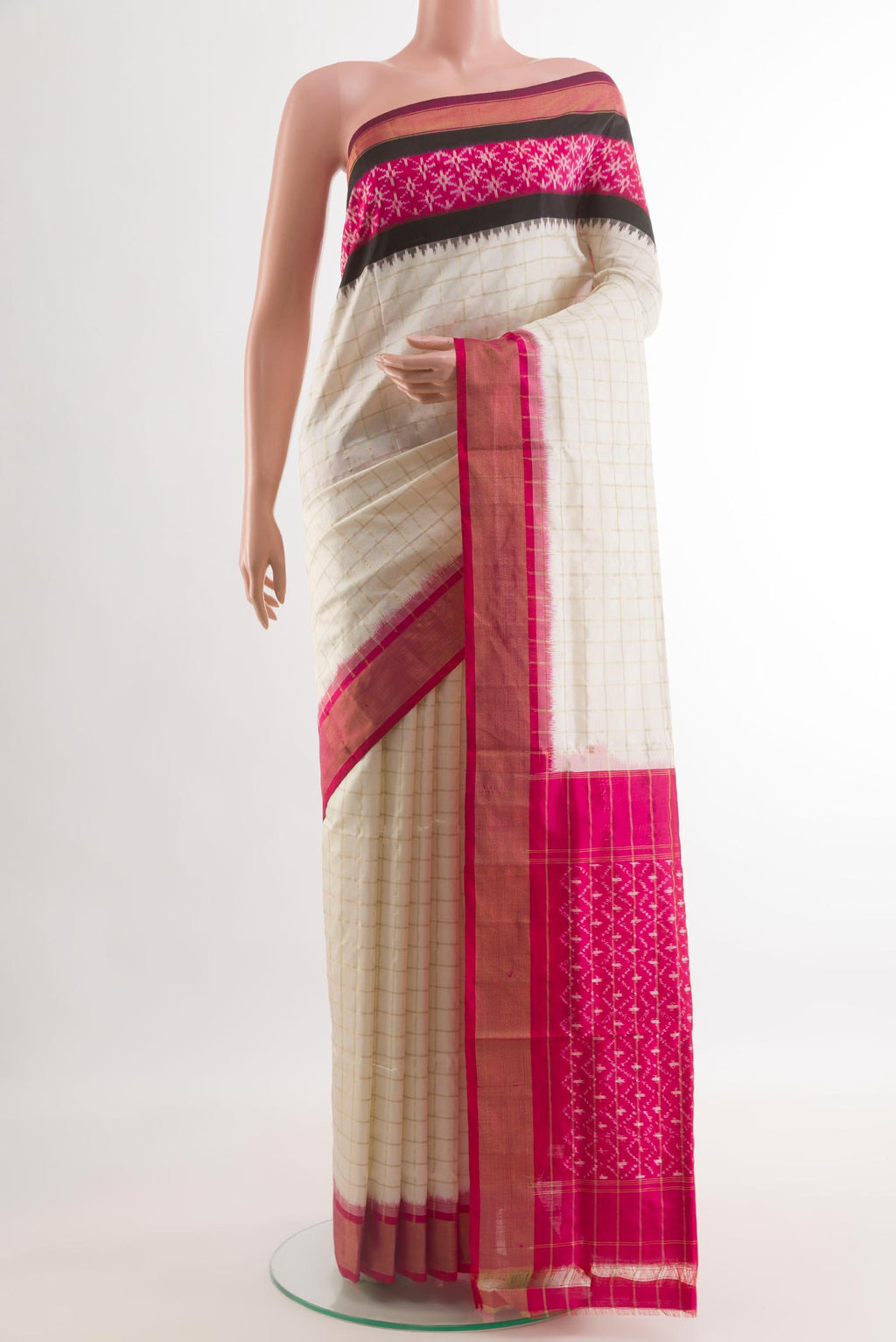 Off White Pochampally Silk Saree with Checked design on the body and Zari Border.  displayed on a mannequin