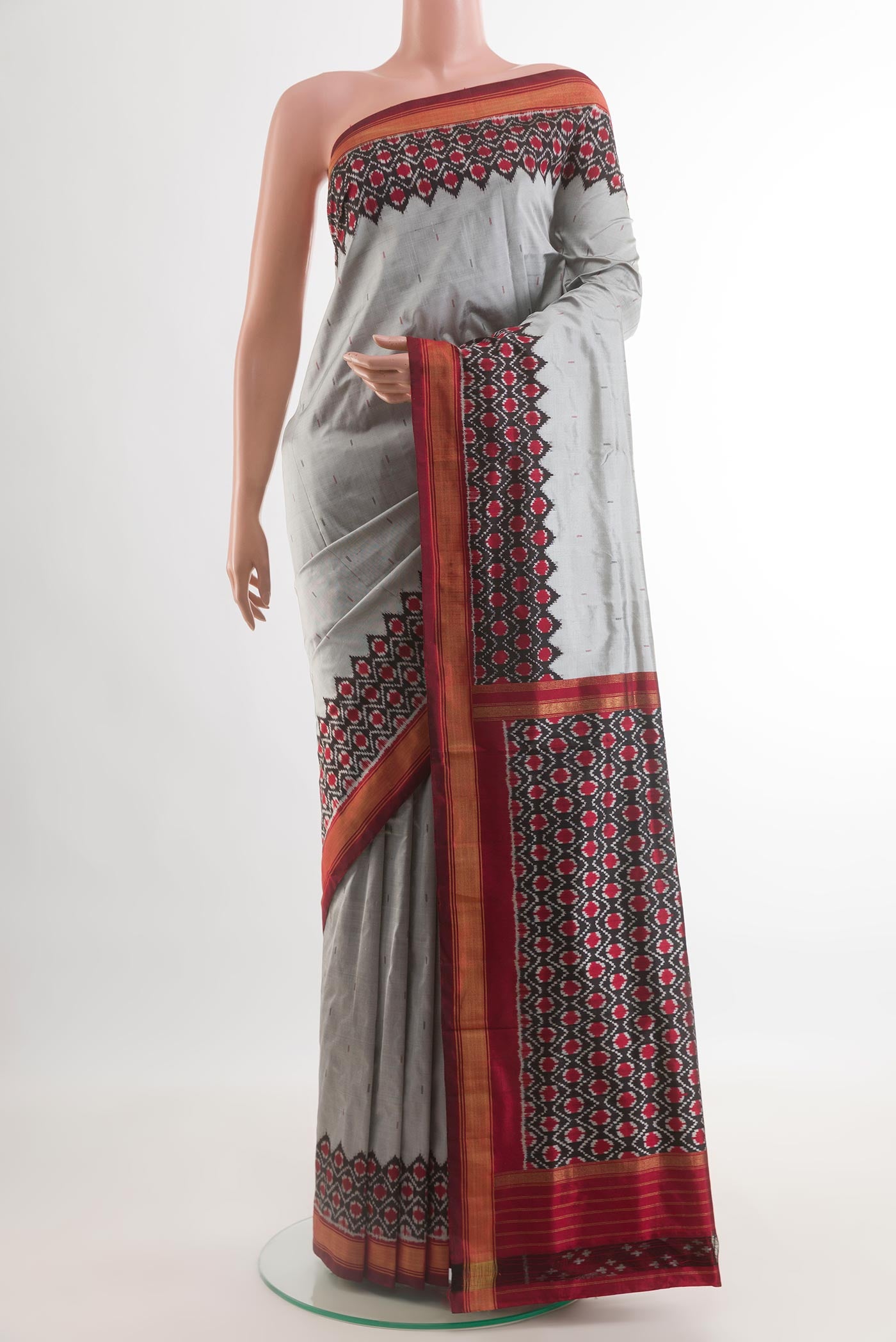 Grey Pochampally Silk Saree with Plain Body and Ikat Border.  displayed on a mannequin