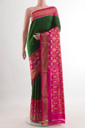Green Pochampally Silk Saree with Plain Body and Ikat Border.  displayed on a mannequin