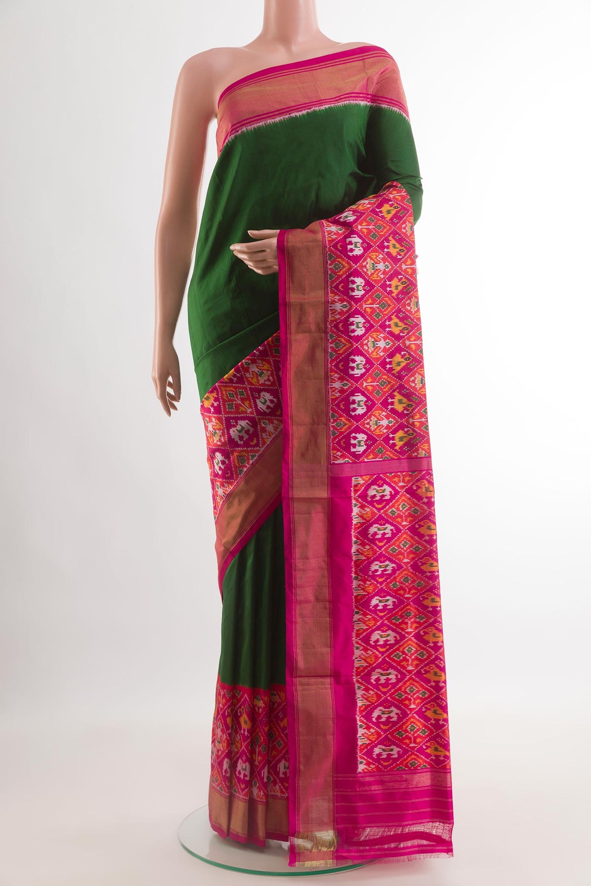 Green Pochampally Silk Saree with Plain Body and Ikat Border.  displayed on a mannequin
