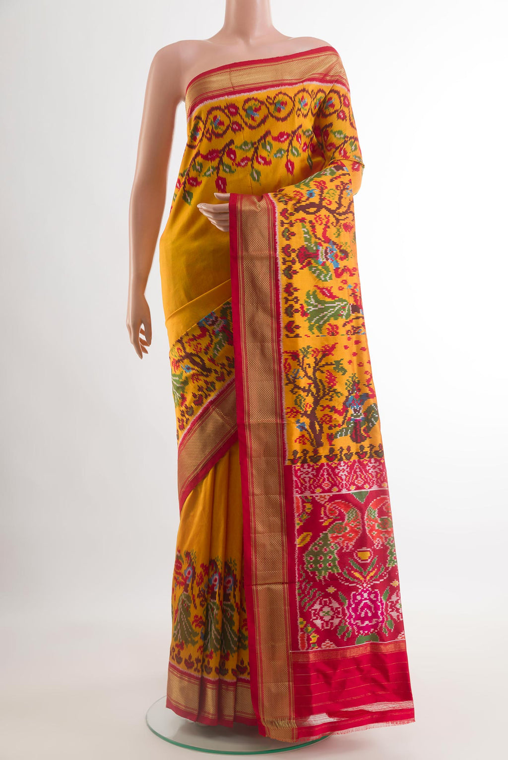 Mustard Pochampally Silk Saree with Plain Body and Ikat Border.  displayed on a mannequin