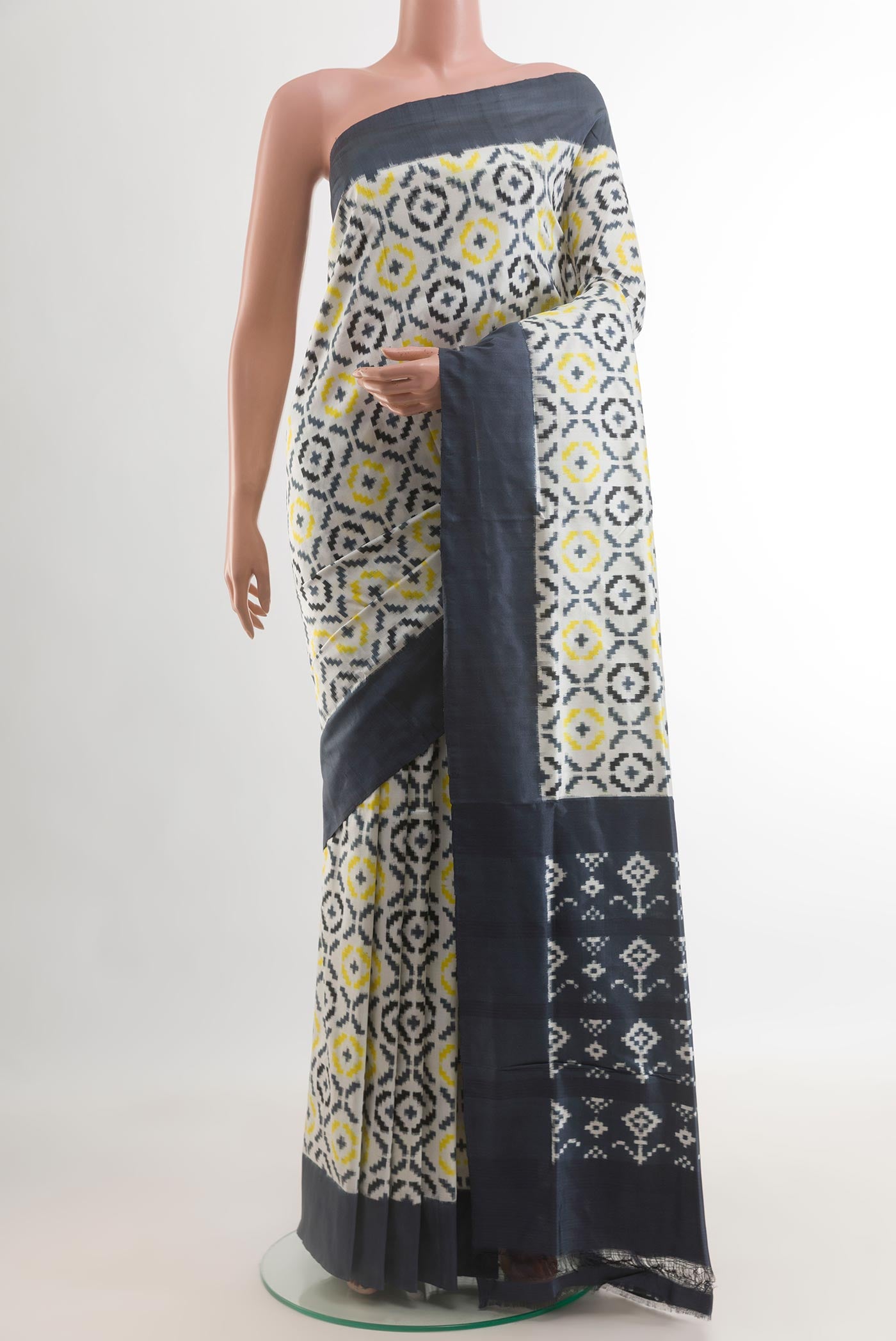 White Pochampally Silk Saree with Pure Ikat on the body and Plain Border.  displayed on a mannequin