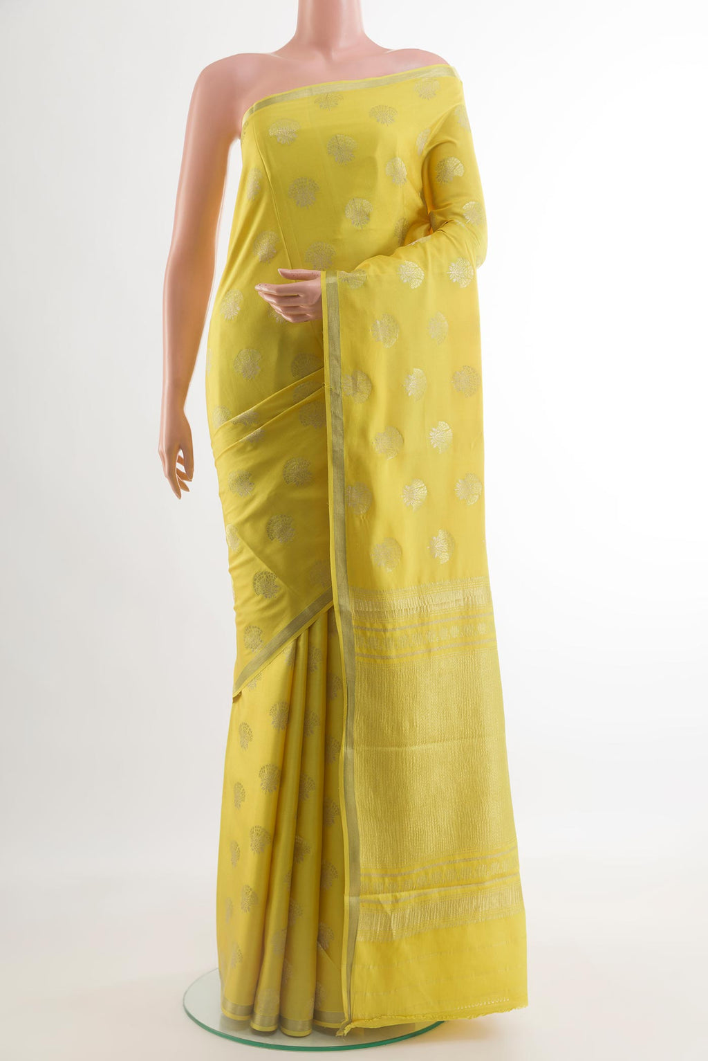 Yellow Mysore Crepe Saree with Zari Butta on the body and Zari Border.  displayed on a mannequin