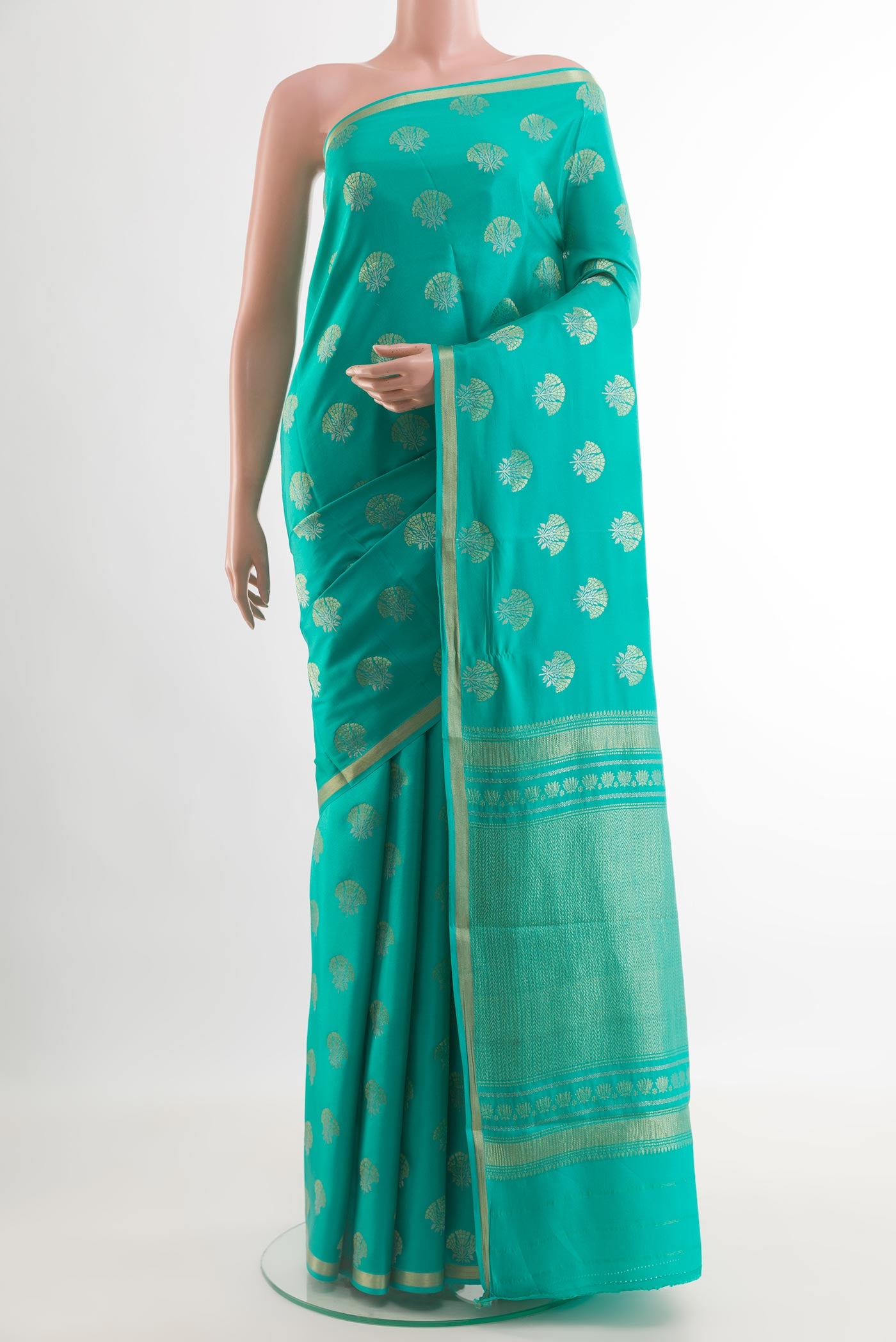 Sea Green Mysore Crepe Saree with Zari Butta on the body and Zari Border.  displayed on a mannequin