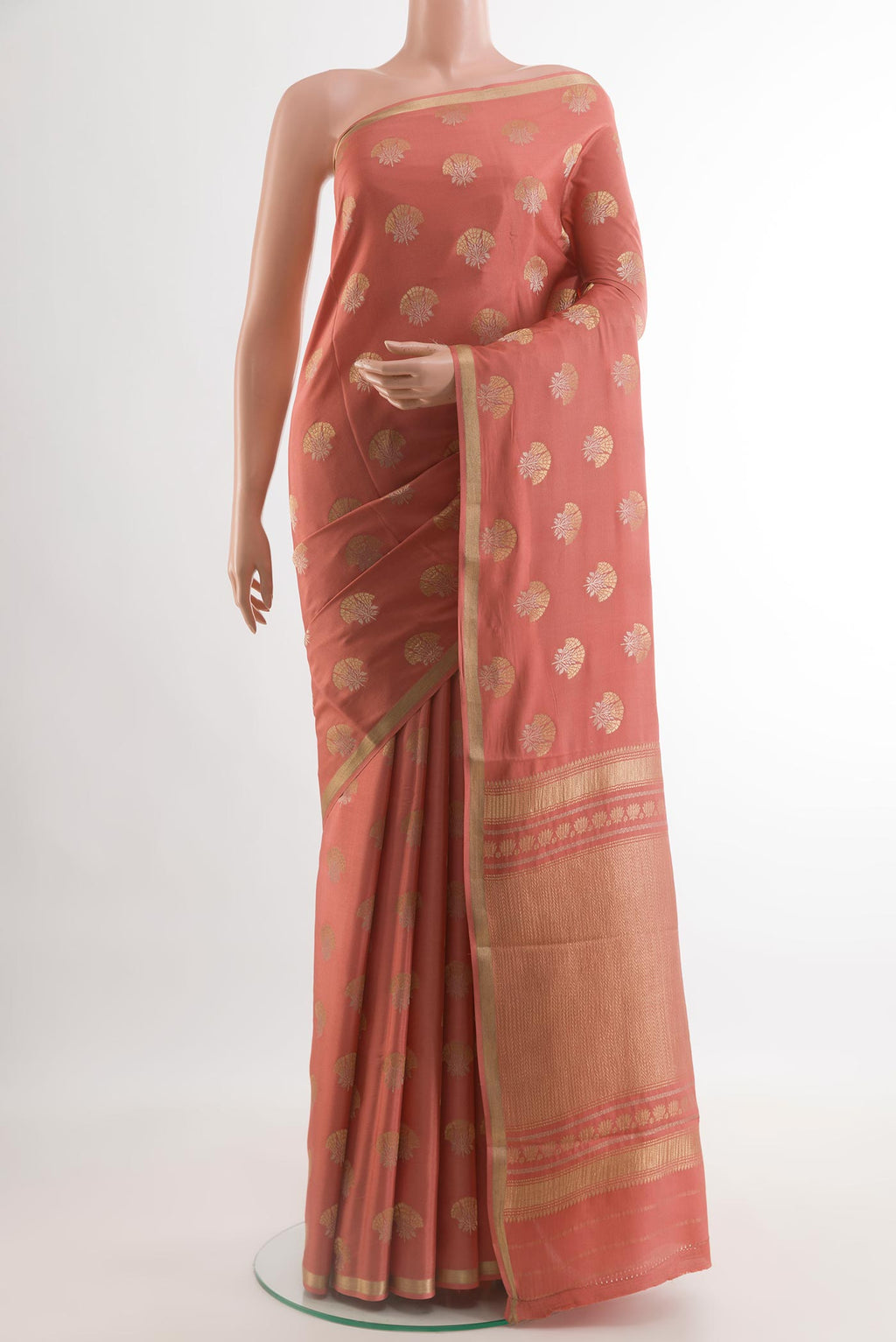 Peach Mysore Crepe Saree with Zari Butta on the body and Zari Border.  displayed on a mannequin