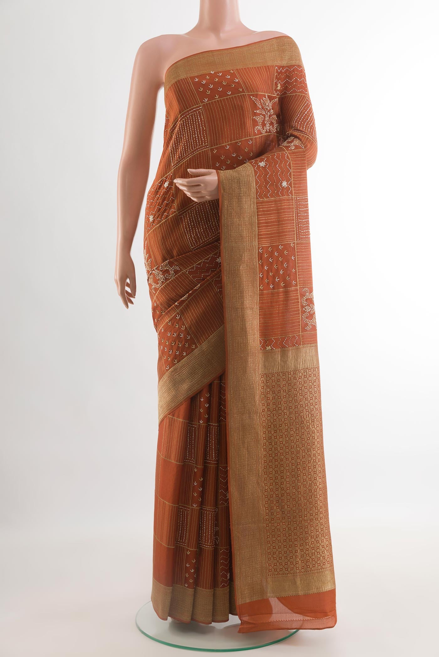 Orange Mysore Crepe Saree with Embroidery on the body and Zari Border.  displayed on a mannequin
