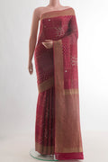 Maroon Mysore Crepe Saree with Embroidery on the body and Zari Border.  displayed on a mannequin