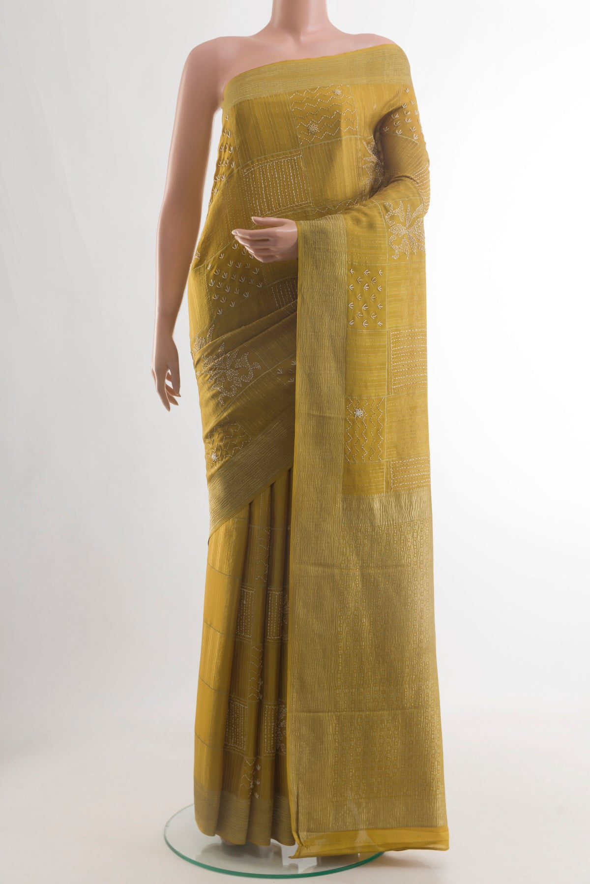 Mehandi Green Mysore Crepe Saree with Embroidery on the body and Zari Border.  displayed on a mannequin