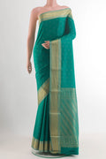 Sea Green Mysore Crepe Saree with Zari Butta on the body and Zari Border.  displayed on a mannequin