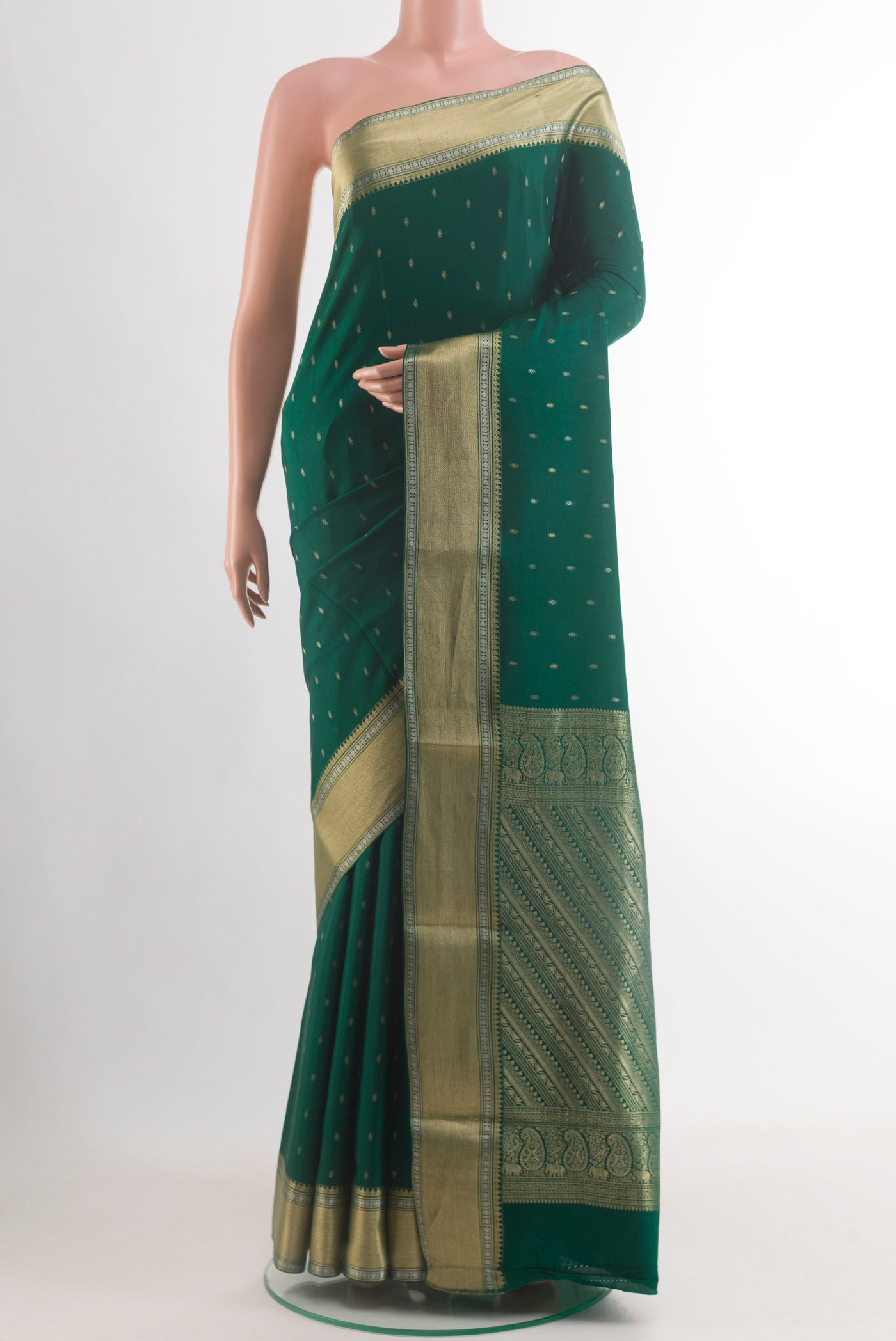 Bottle Green Mysore Crepe Saree with Zari Butta on the body and Zari Border.  displayed on a mannequin