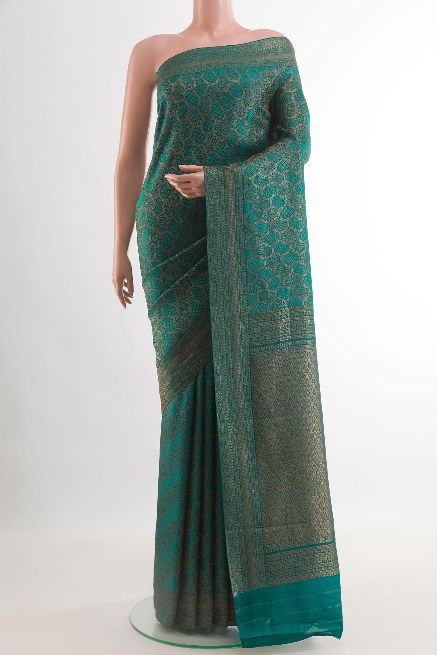 Teal Mysore Crepe Saree with Zari Brocade on the body and Zari Border.  displayed on a mannequin