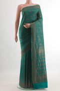 Teal Mysore Crepe Saree with Zari Brocade on the body and Zari Border.  displayed on a mannequin