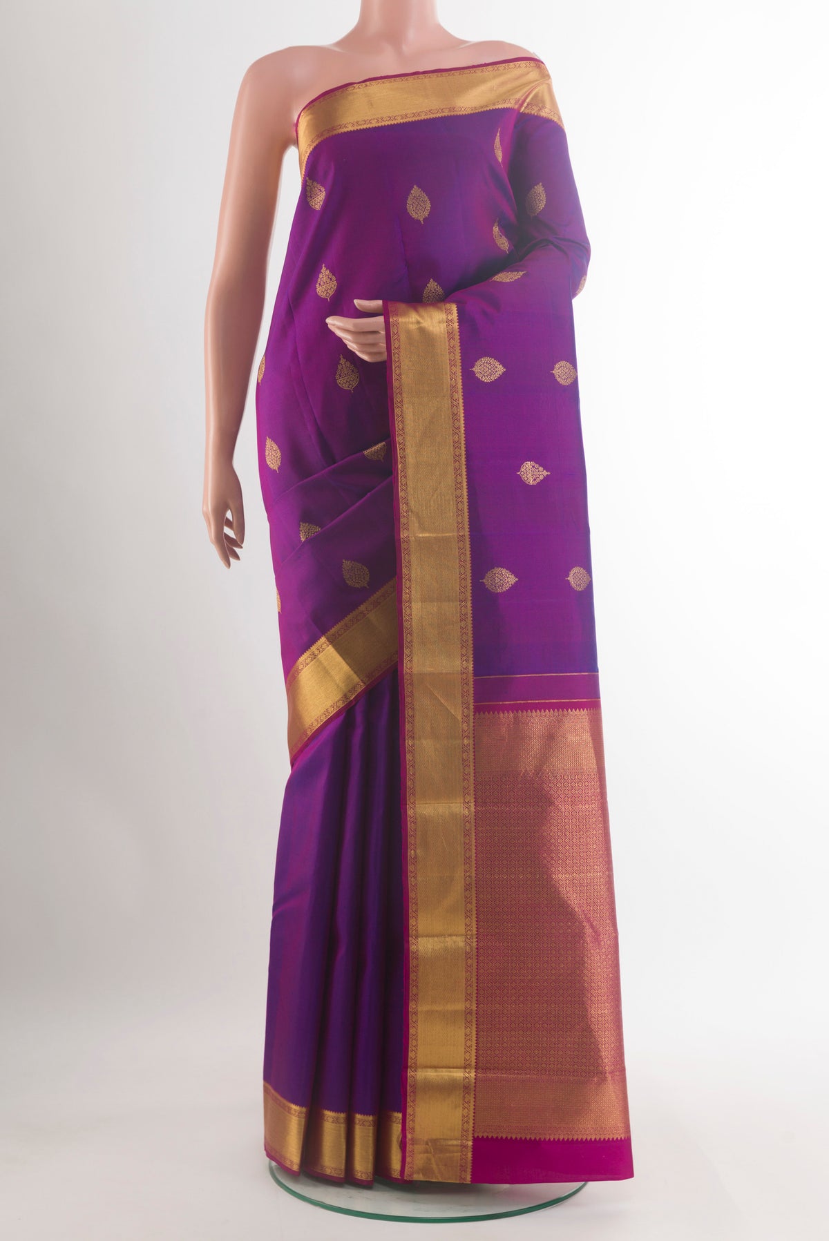 Pure Silk Purple Kanchipuram Saree with Zari Butta on the body and Zari Border.  displayed on a mannequin