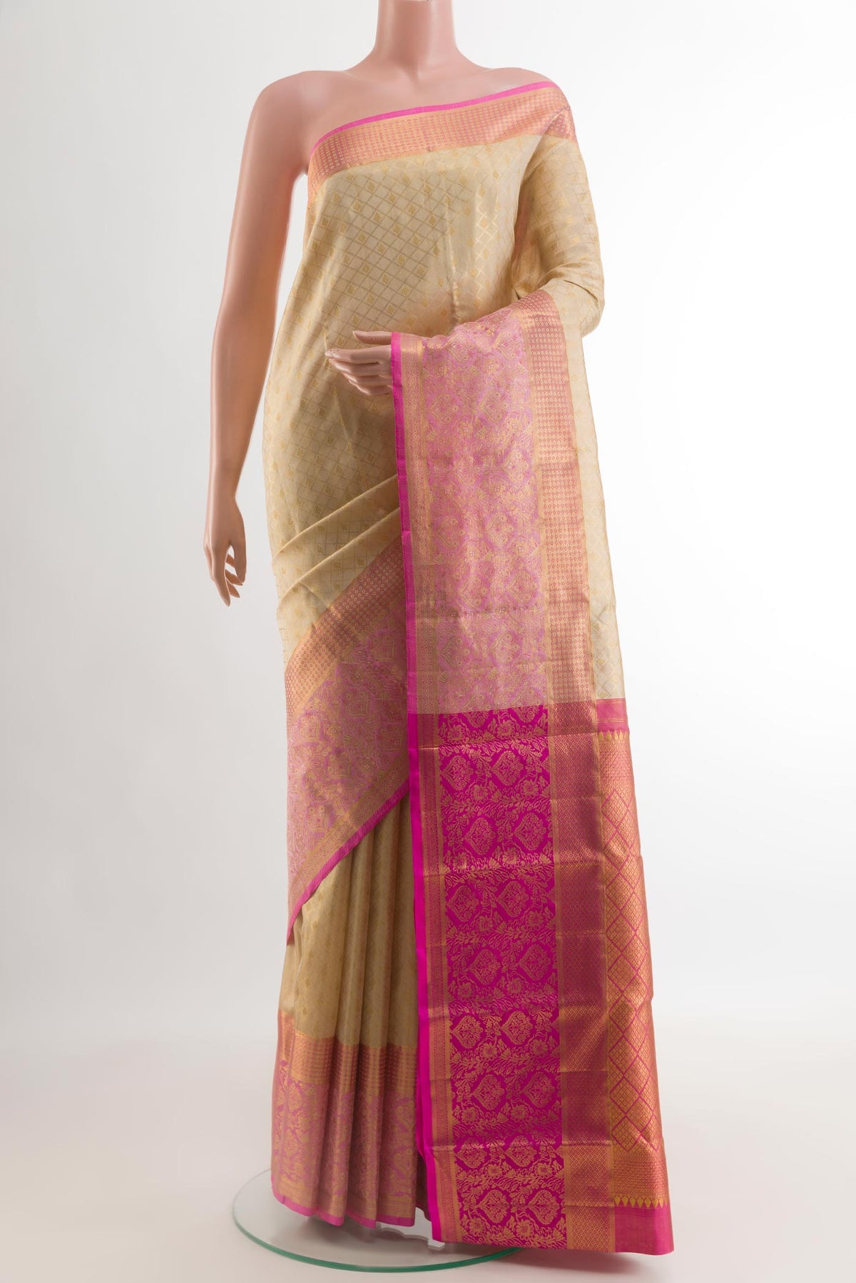 Cream Kanjivaram Silk Saree with Zari Brocade on the body and Zari Border.  displayed on a mannequin