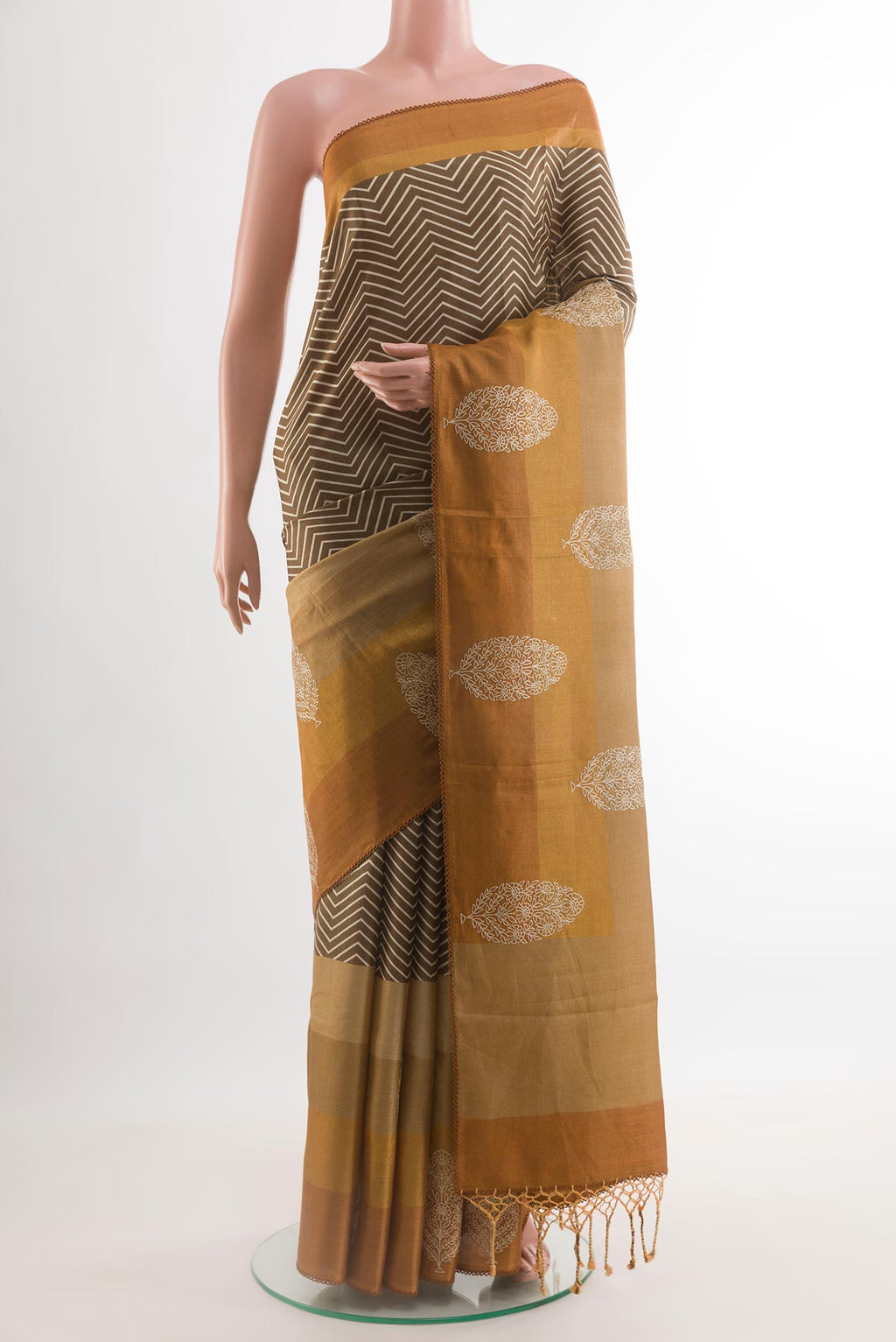 Olive Green Tussar Silk Saree with Printed design on the body and Embroidery Border.  displayed on a mannequin