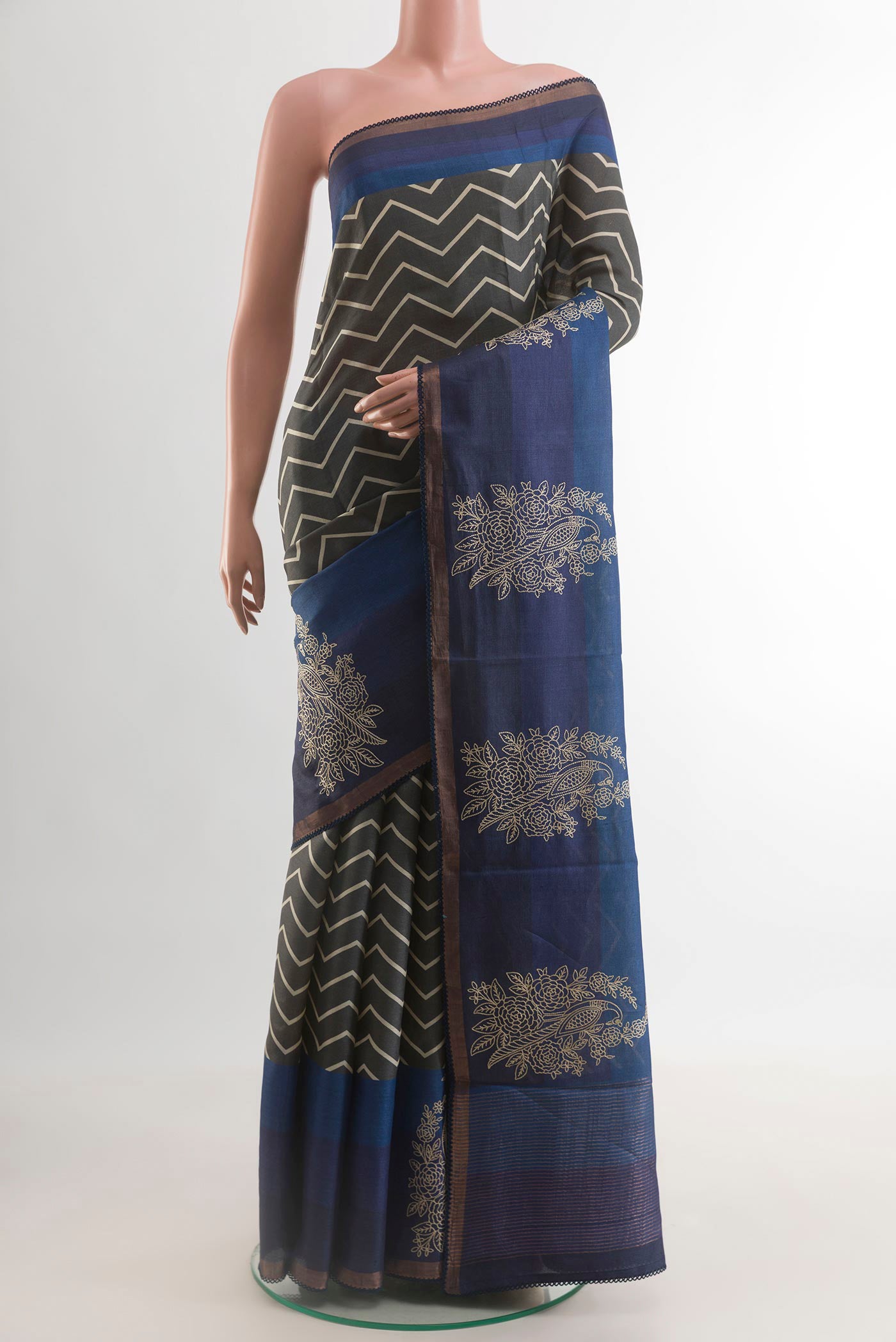 Grey Tussar Silk Saree with Printed design on the body and Zari Border.  displayed on a mannequin