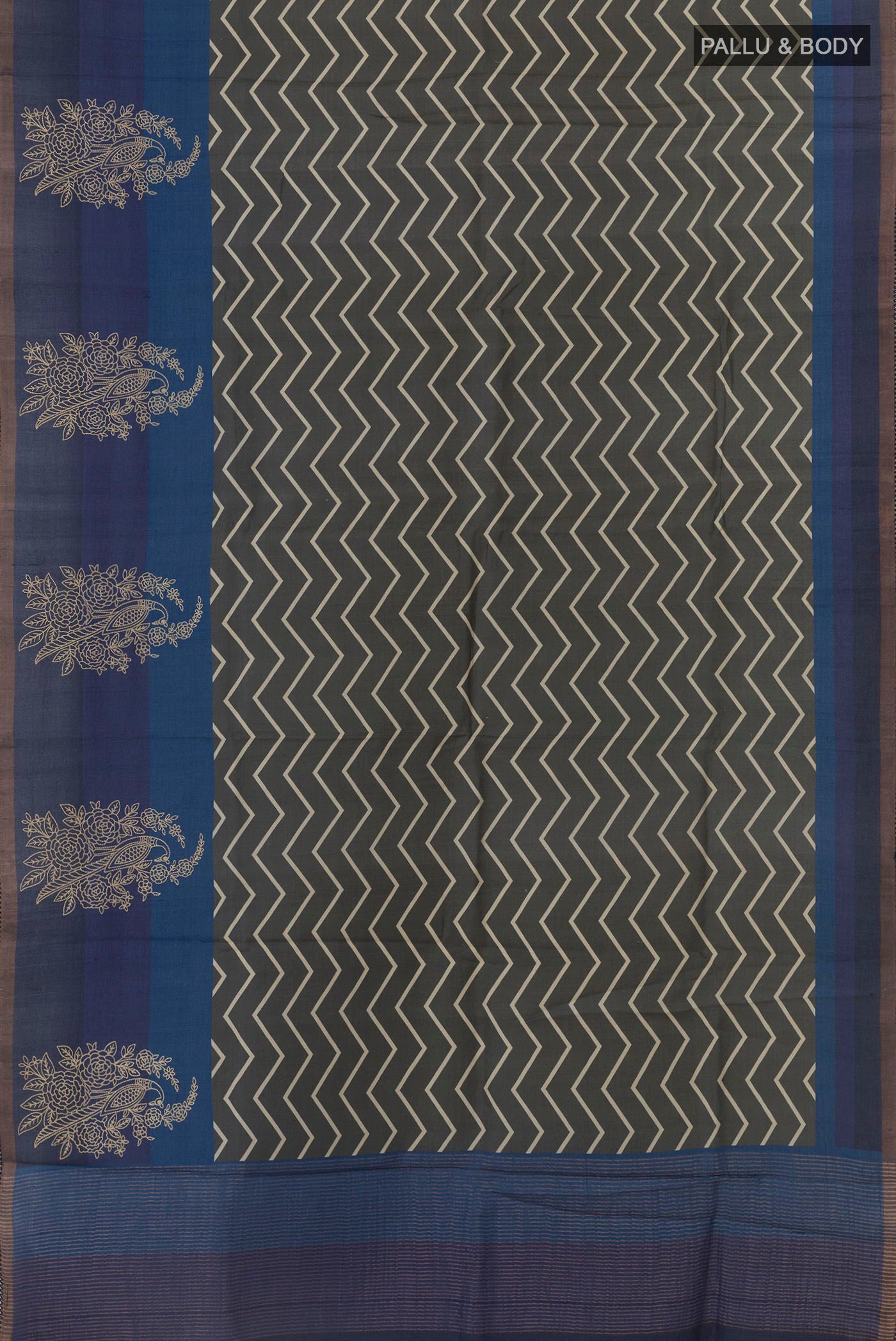 Flat view of Grey Tussar Silk Saree with Printed design on the body and Zari Border. 