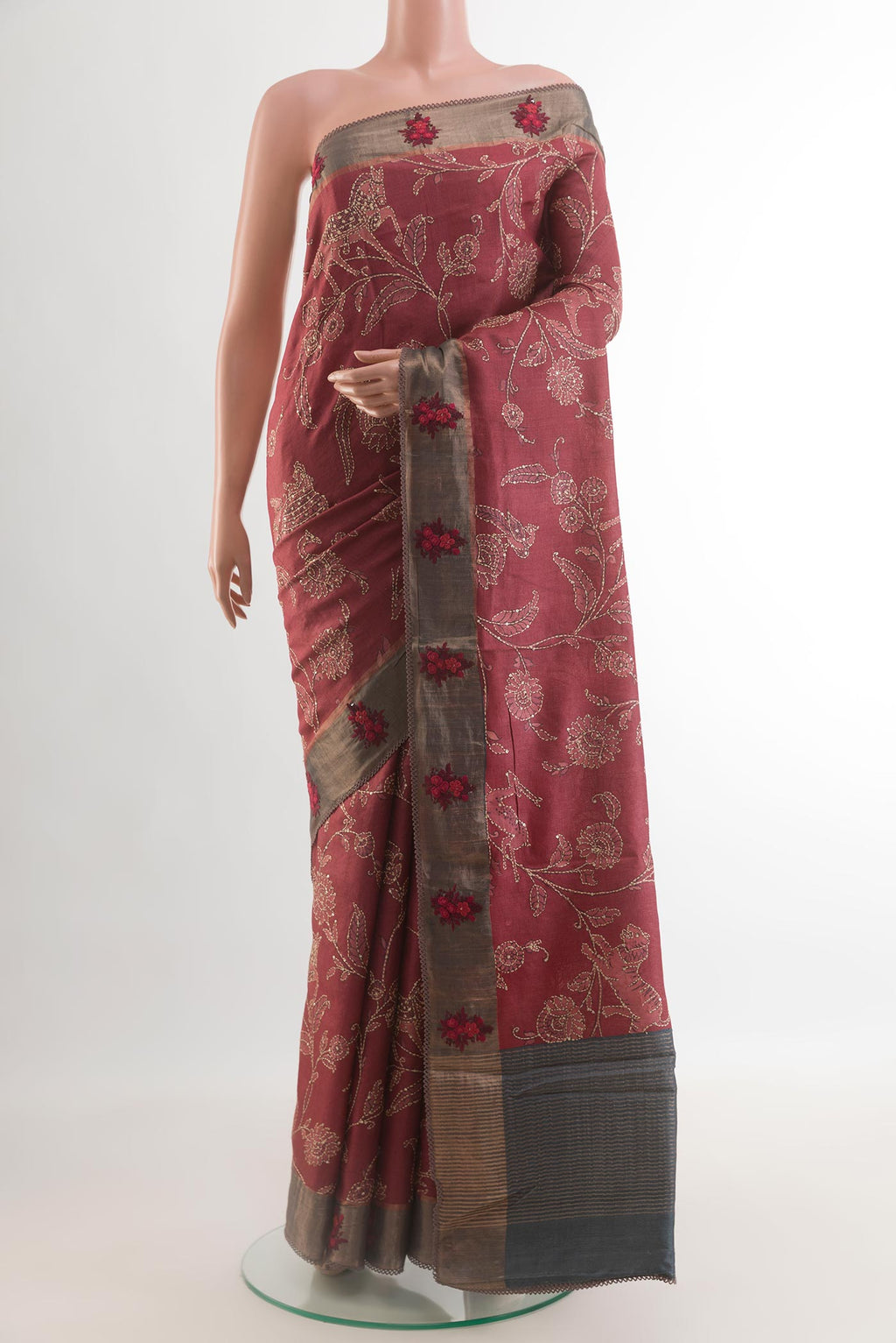Maroon Tussar Silk Saree with Embroidery on the body and Zari Border.  displayed on a mannequin