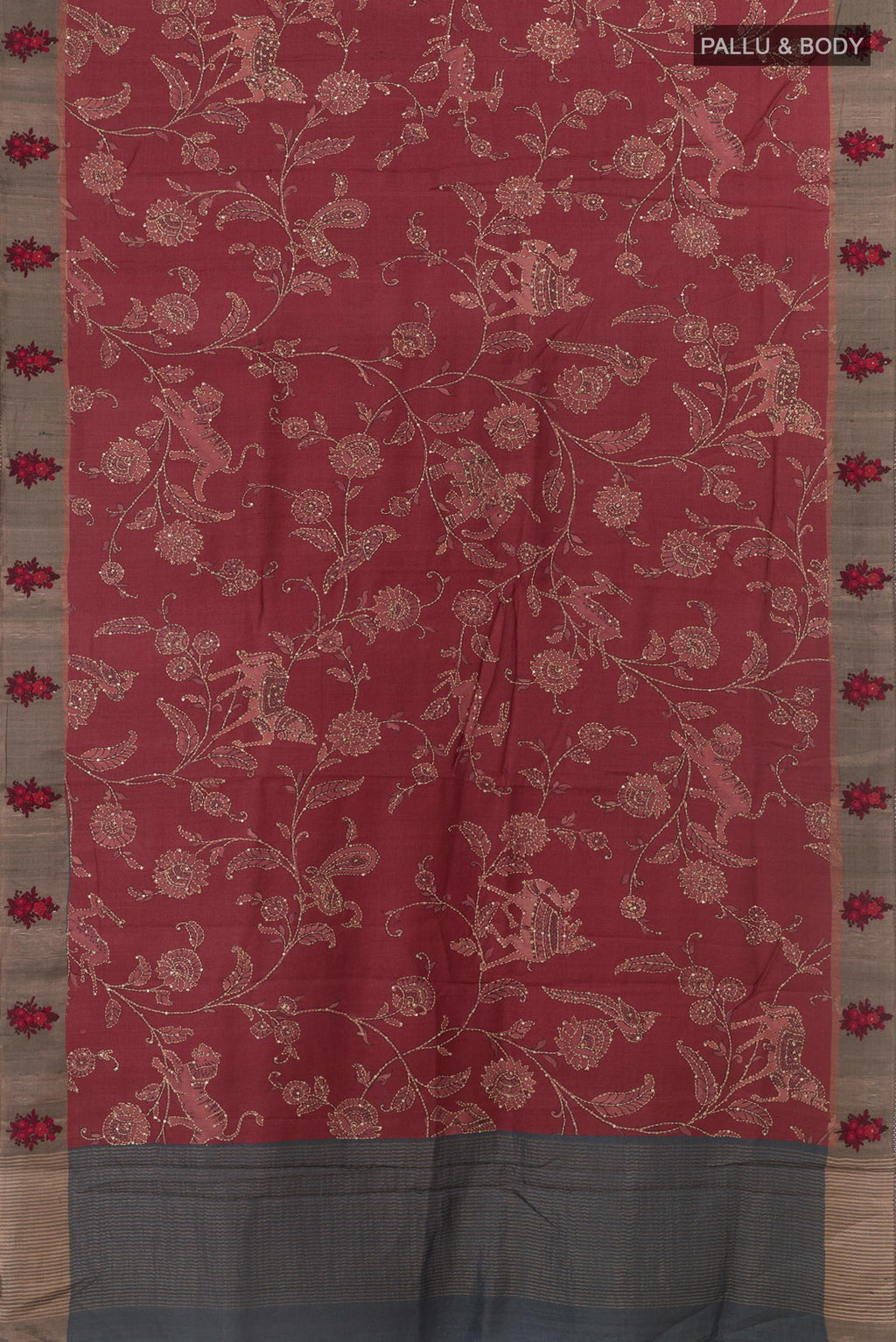 Flat view of Maroon Tussar Silk Saree with Embroidery on the body and Zari Border. 
