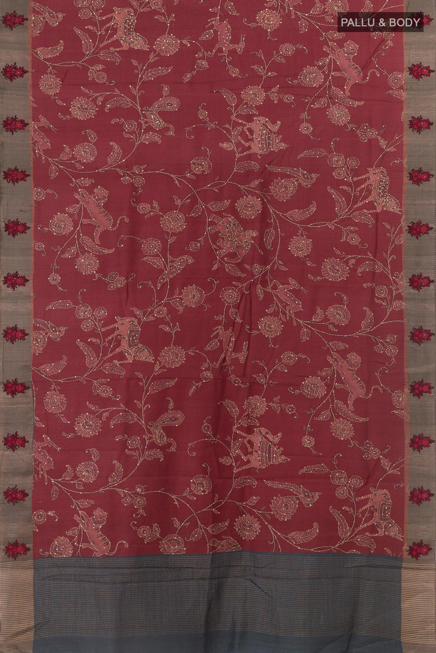 Flat view of Maroon Tussar Silk Saree with Embroidery on the body and Zari Border. 