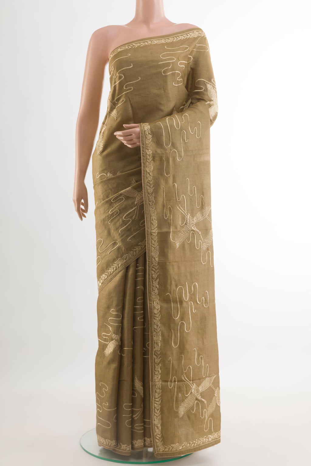 Beige Tussar Silk Saree with Embroidery on the body and Embroidery Border.  displayed on a mannequin