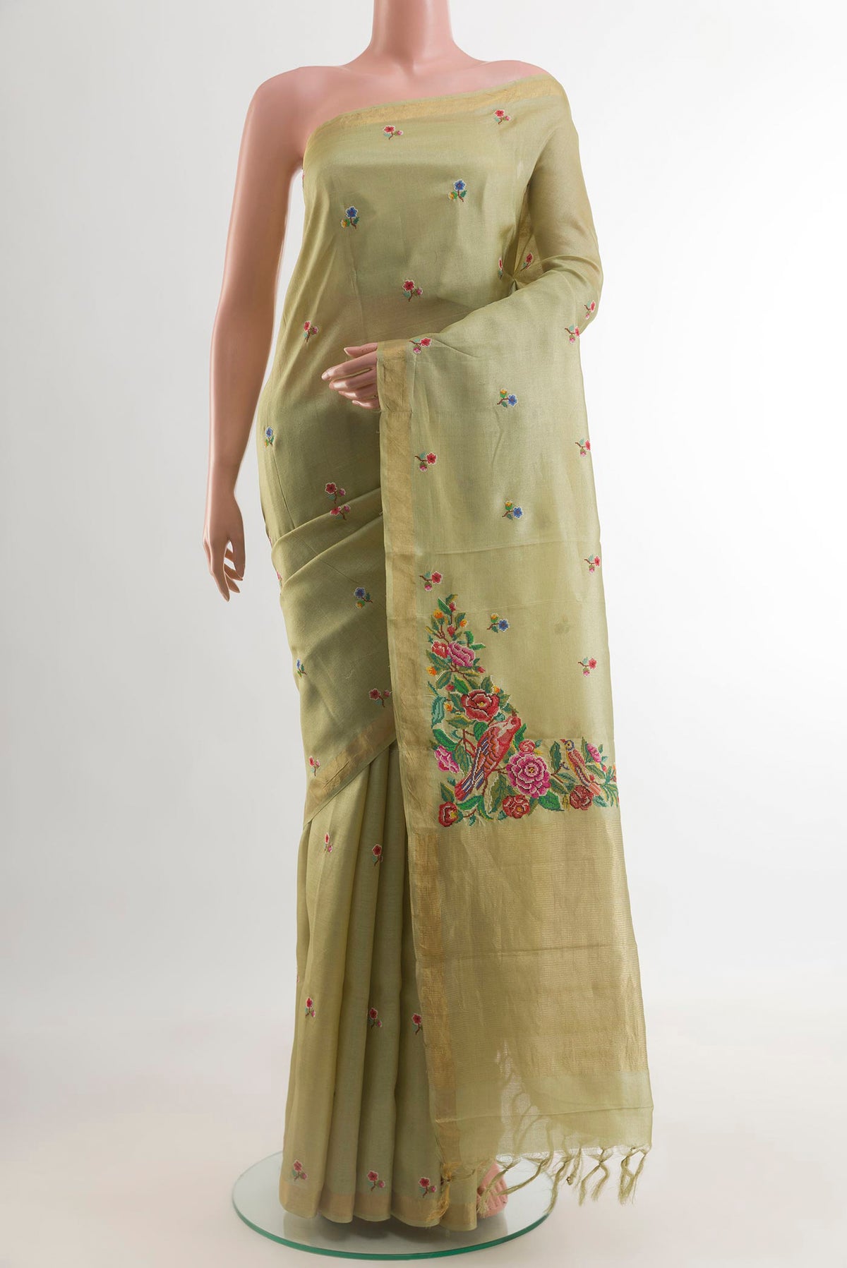 Beige Tussar Silk Saree with Embroidery on the body and Zari Border.  displayed on a mannequin