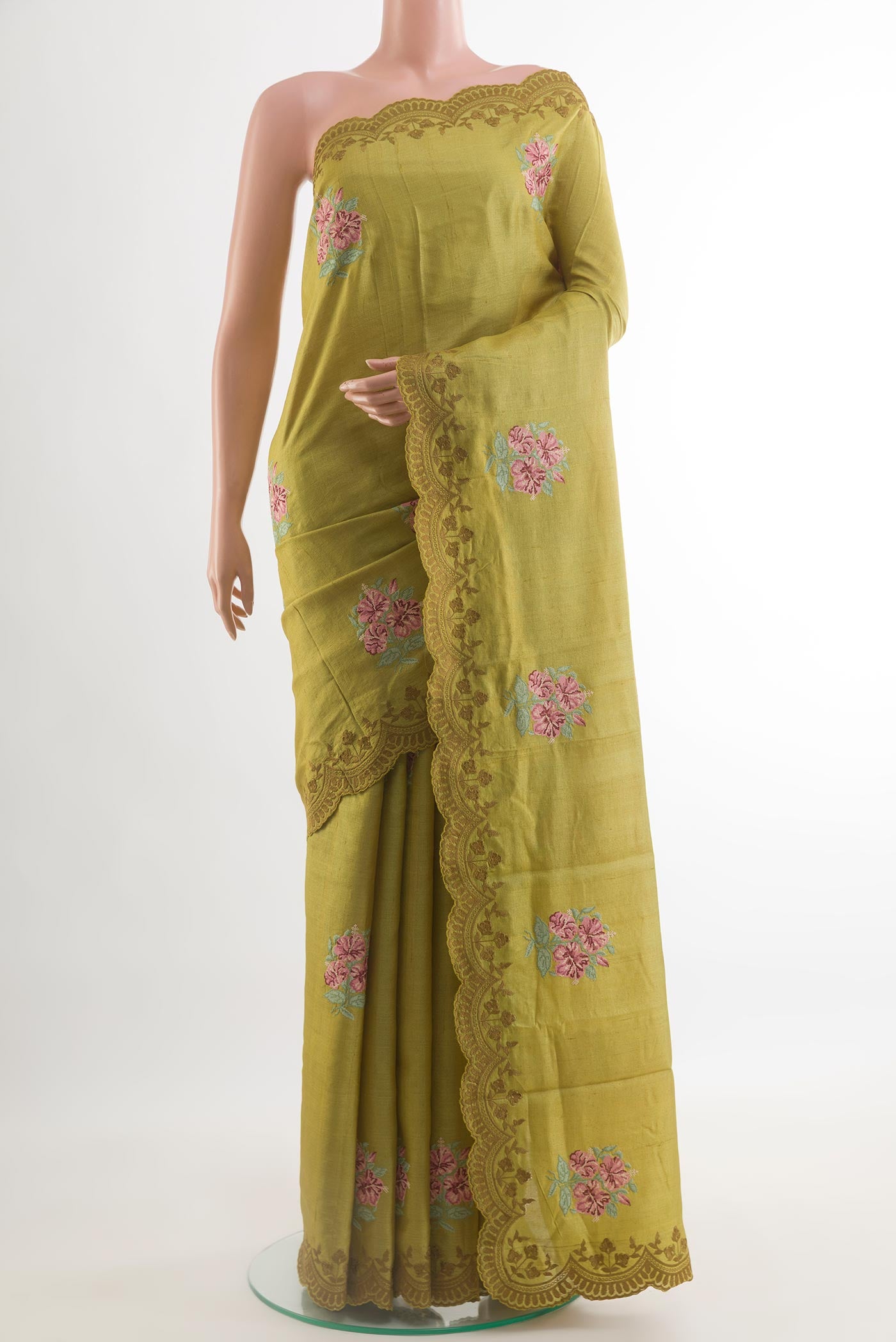 Green Tussar Saree with Embroidery on the body and Embroidery Border.  displayed on a mannequin