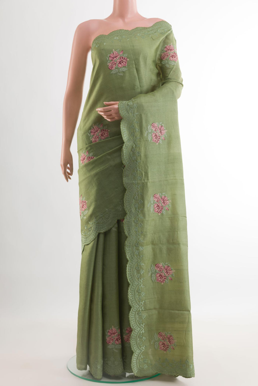 Sage Green Tussar Silk Saree with Embroidery on the body and Embroidery Border.  displayed on a mannequin