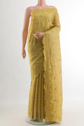 Mustard Tussar Silk Saree with Embroidery on the body and Embroidery Border.  displayed on a mannequin