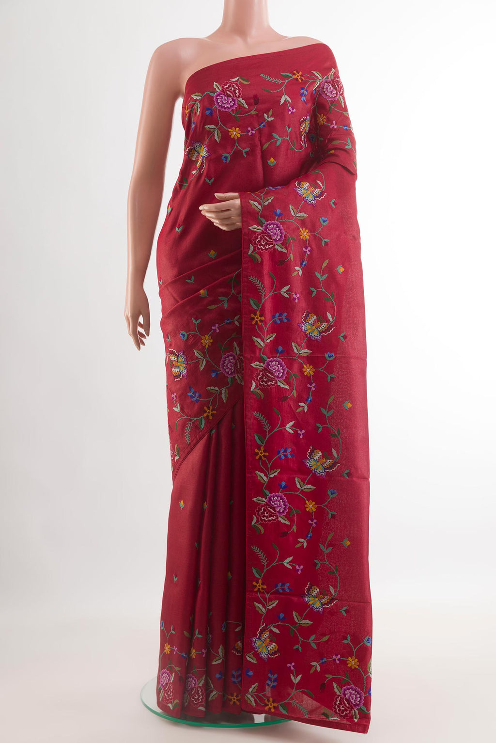 Red Tussar Saree with Embroidery on the body and Embroidery Border.  displayed on a mannequin