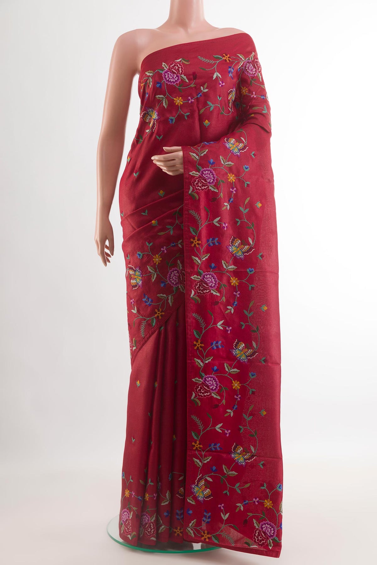 Red Tussar Saree with Embroidery on the body and Embroidery Border.  displayed on a mannequin