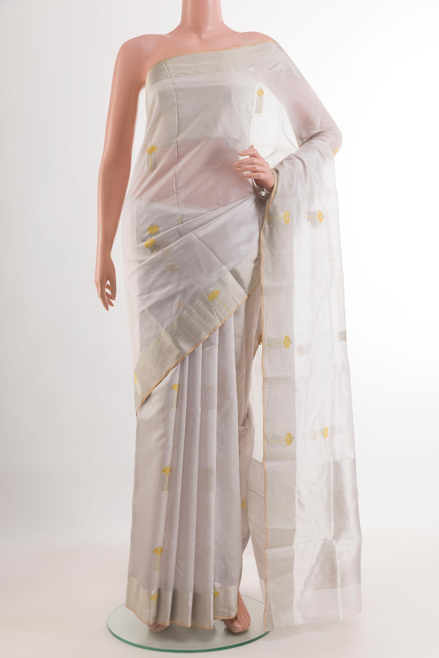 Off White Chanderi Silk Saree with Zari Butta on the body and Zari Border.  displayed on a mannequin