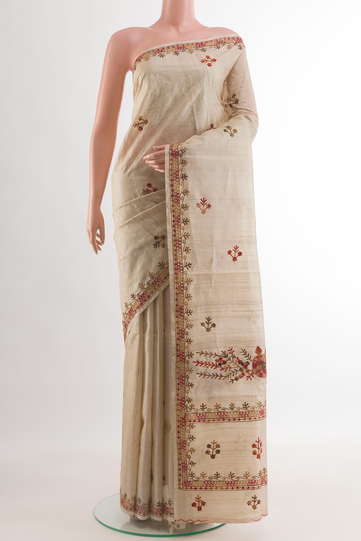 Beige Tussar Silk Saree with Embroidery on the body and Embroidery Border.  displayed on a mannequin