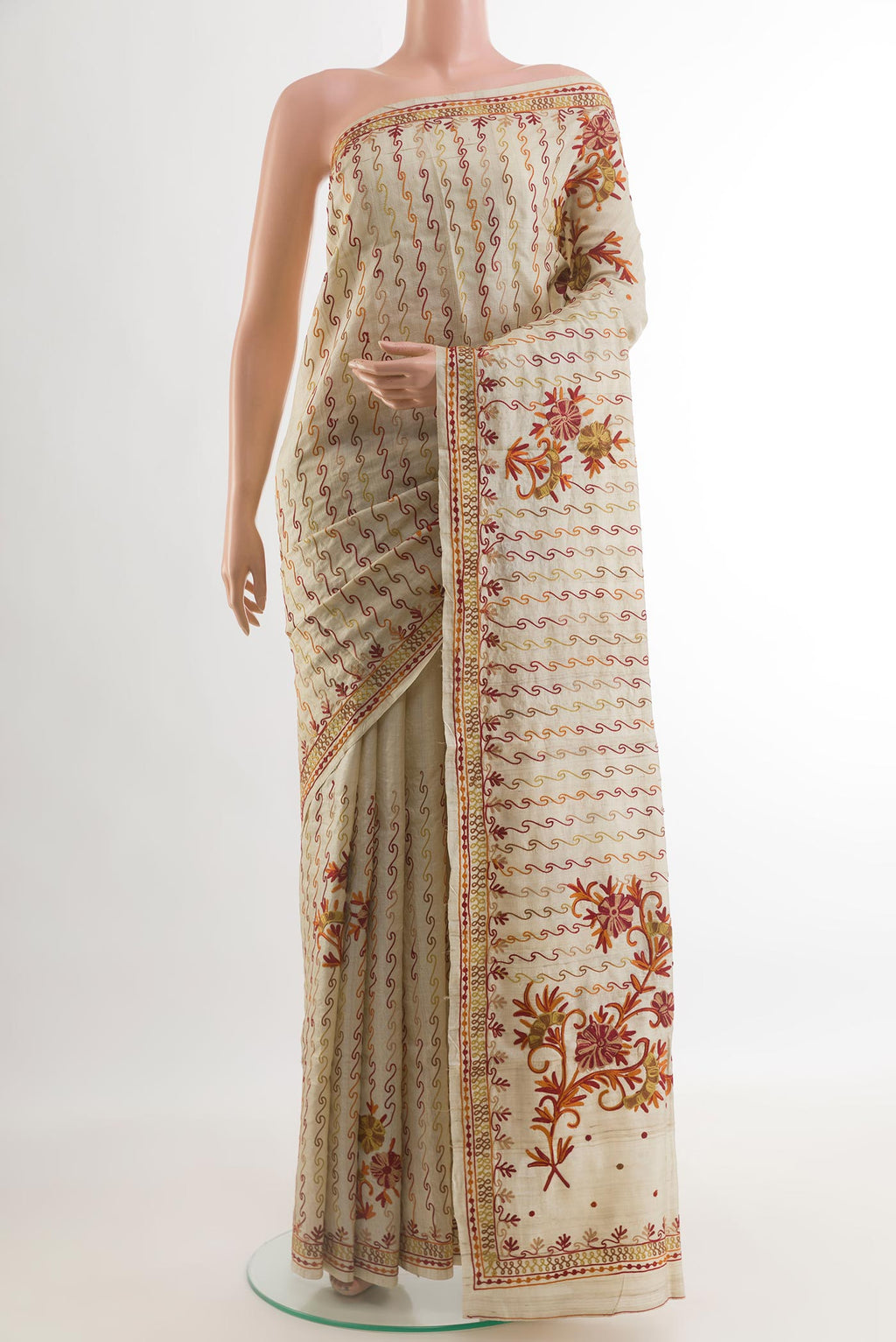 Beige Tussar Silk Saree with Embroidery on the body and Embroidery Border.  displayed on a mannequin