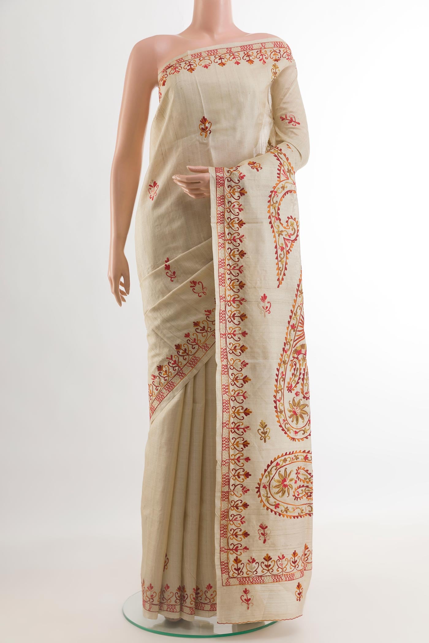 Beige Tussar Silk Saree with Embroidery on the body and Embroidery Border.  displayed on a mannequin