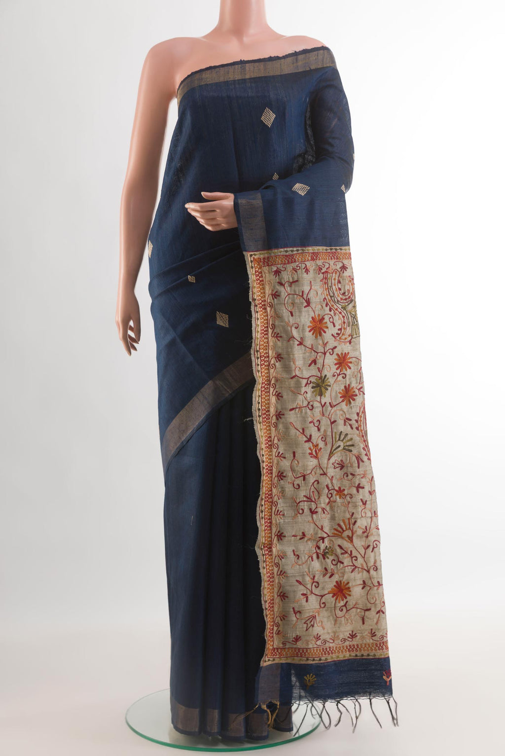 Blue Tussar Silk Saree with Thread Butta on the body and Zari Border.  displayed on a mannequin