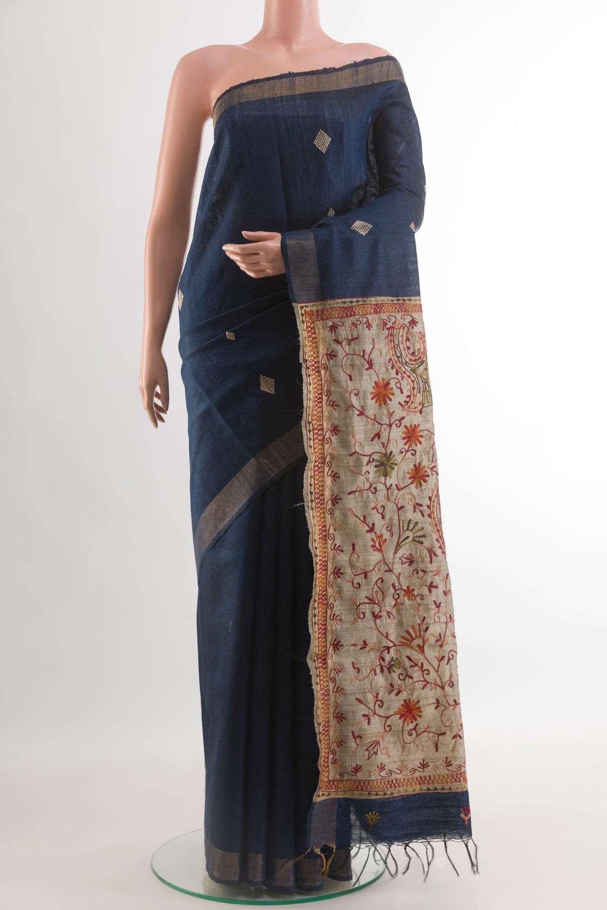 Blue Tussar Silk Saree with Thread Butta on the body and Zari Border.  displayed on a mannequin