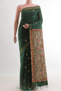 Bottle Green Tussar Silk Saree with Thread Butta on the body and Zari Border.  displayed on a mannequin