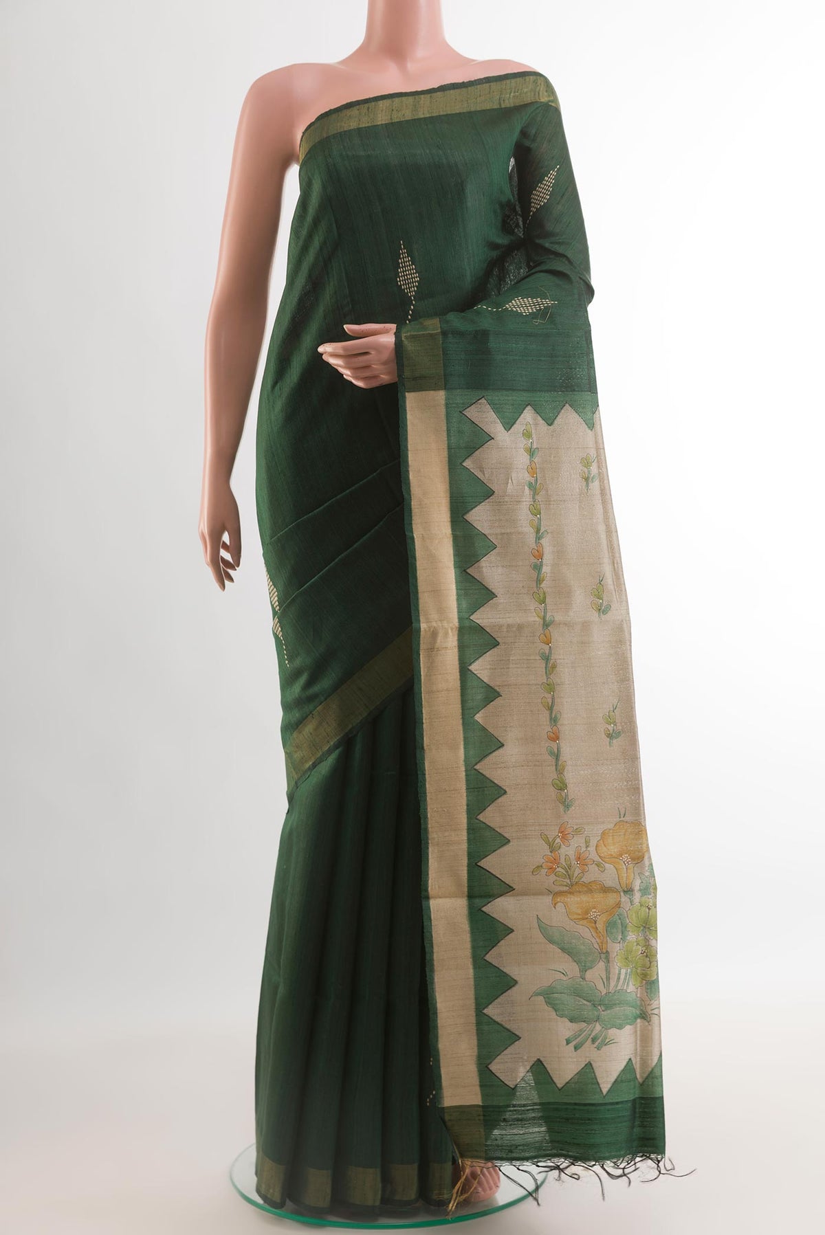 Bottle Green Tussar Silk Saree with Thread Butta on the body and Zari Border.  displayed on a mannequin