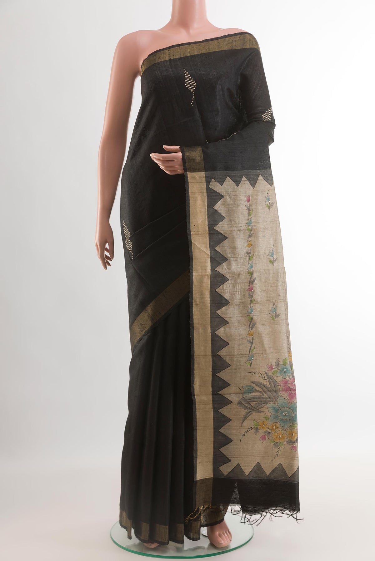 Black Tussar Silk Saree with Thread Butta on the body and Zari Border.  displayed on a mannequin