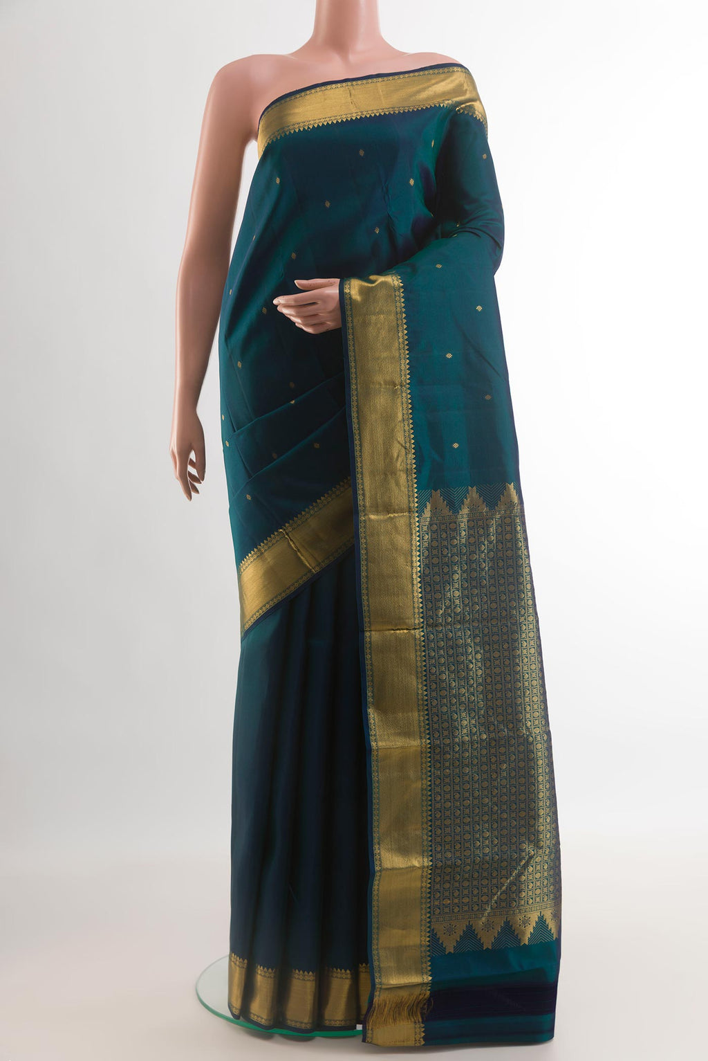 Peacock Blue Kanjivaram Silk Saree with Zari Butta on the body and Zari Border.  displayed on a mannequin