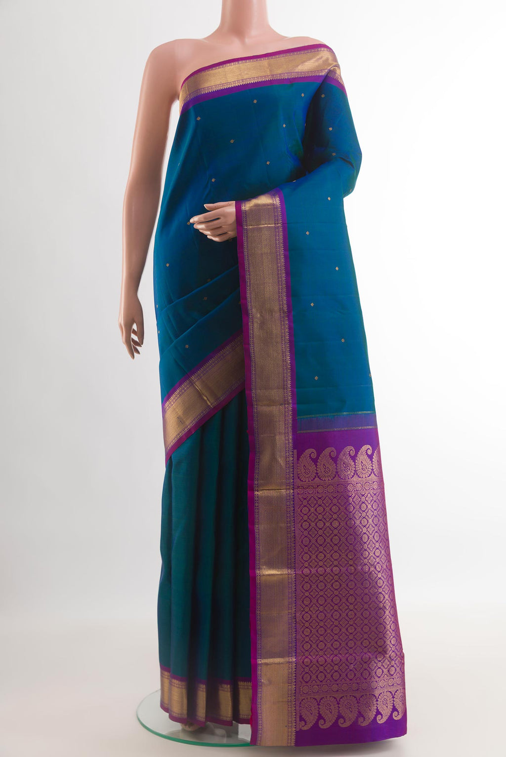 Peacock Blue Kanchipuram Silk Saree with Zari Butta on the body and Zari Border.  displayed on a mannequin