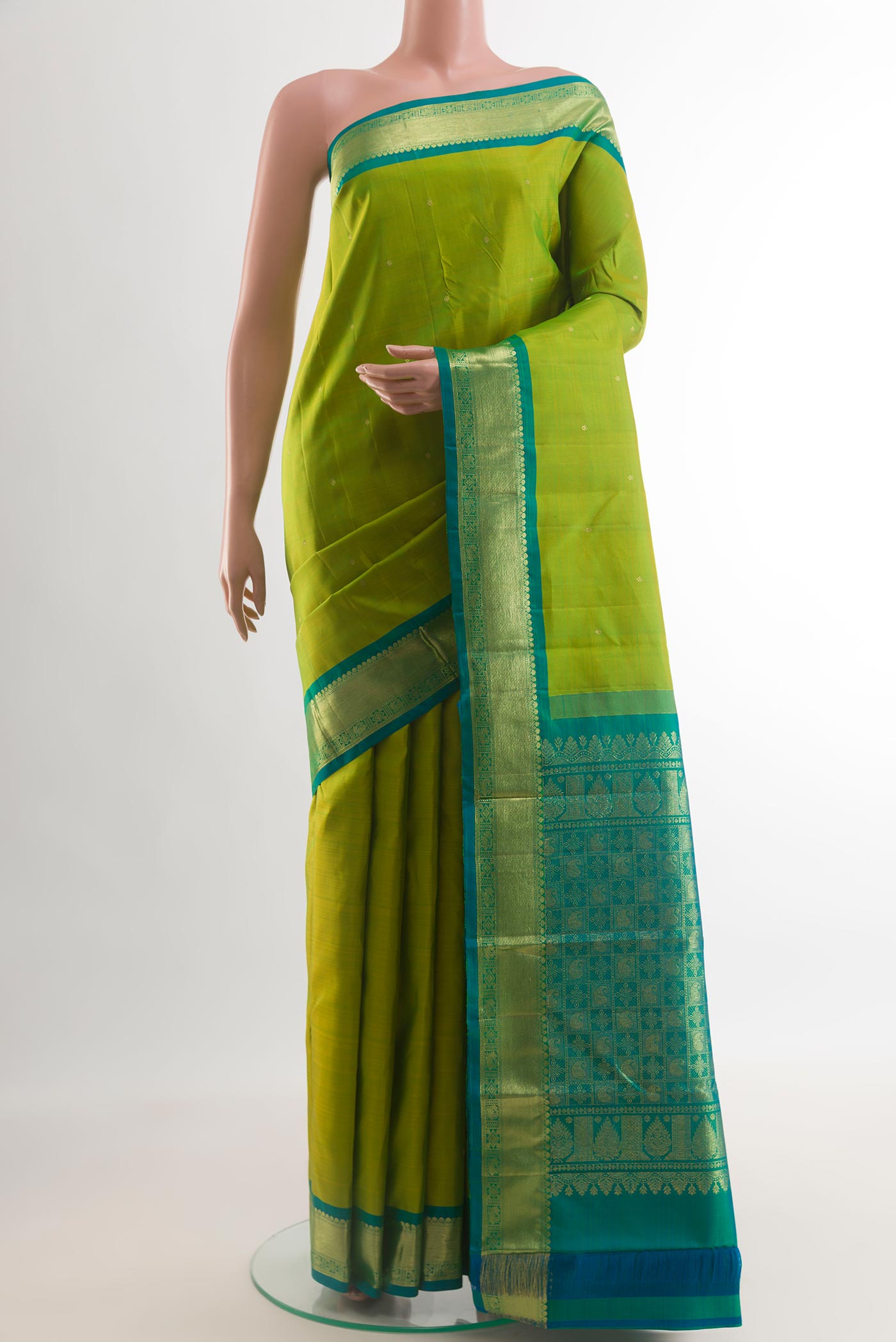 Green Kanchipuram Silk Saree with Zari Butta on the body and Zari Border.  displayed on a mannequin