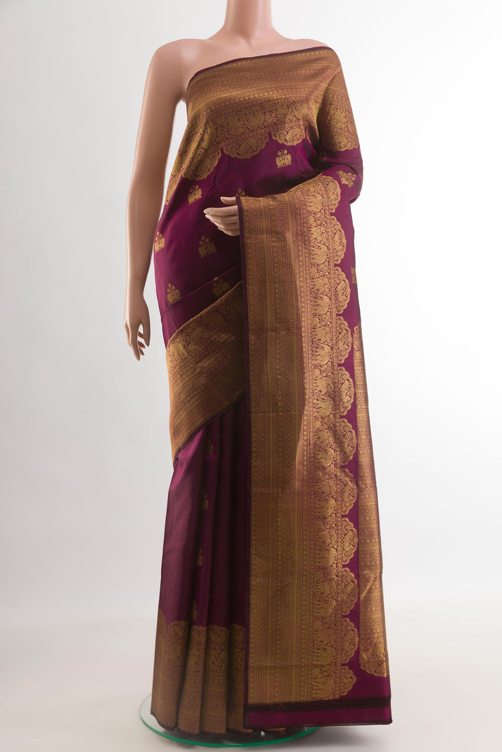 Purple Kanchipuram Silk Saree with Zari Butta on the body and Zari Border.  displayed on a mannequin