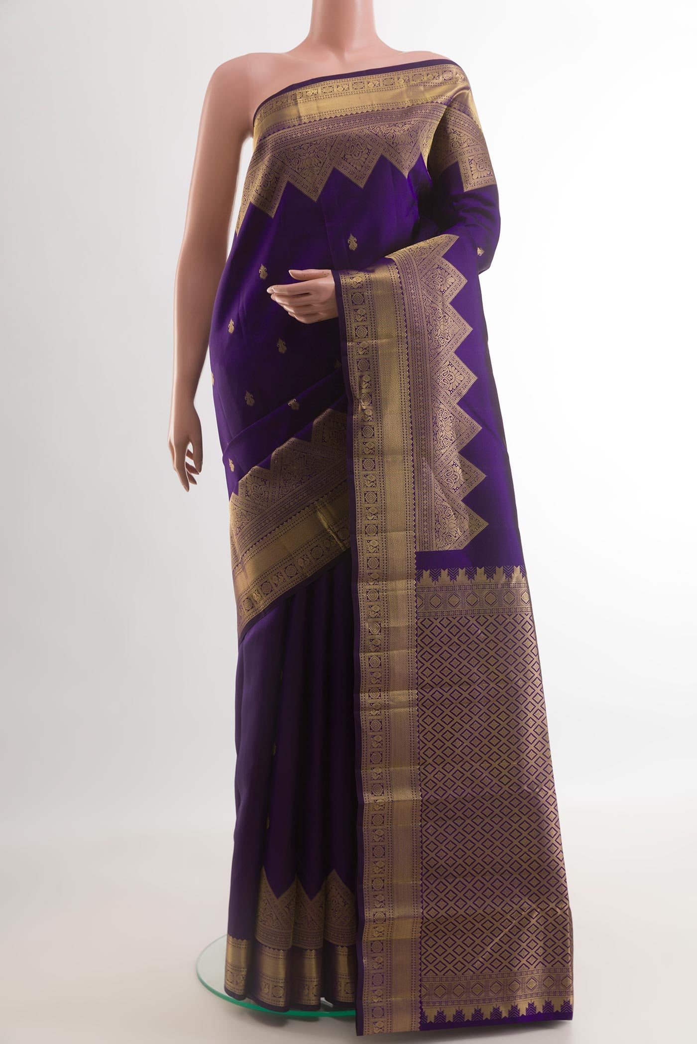 Dark Blue Kanchipuram Silk Saree with Zari Butta on the body and Zari Border.  displayed on a mannequin